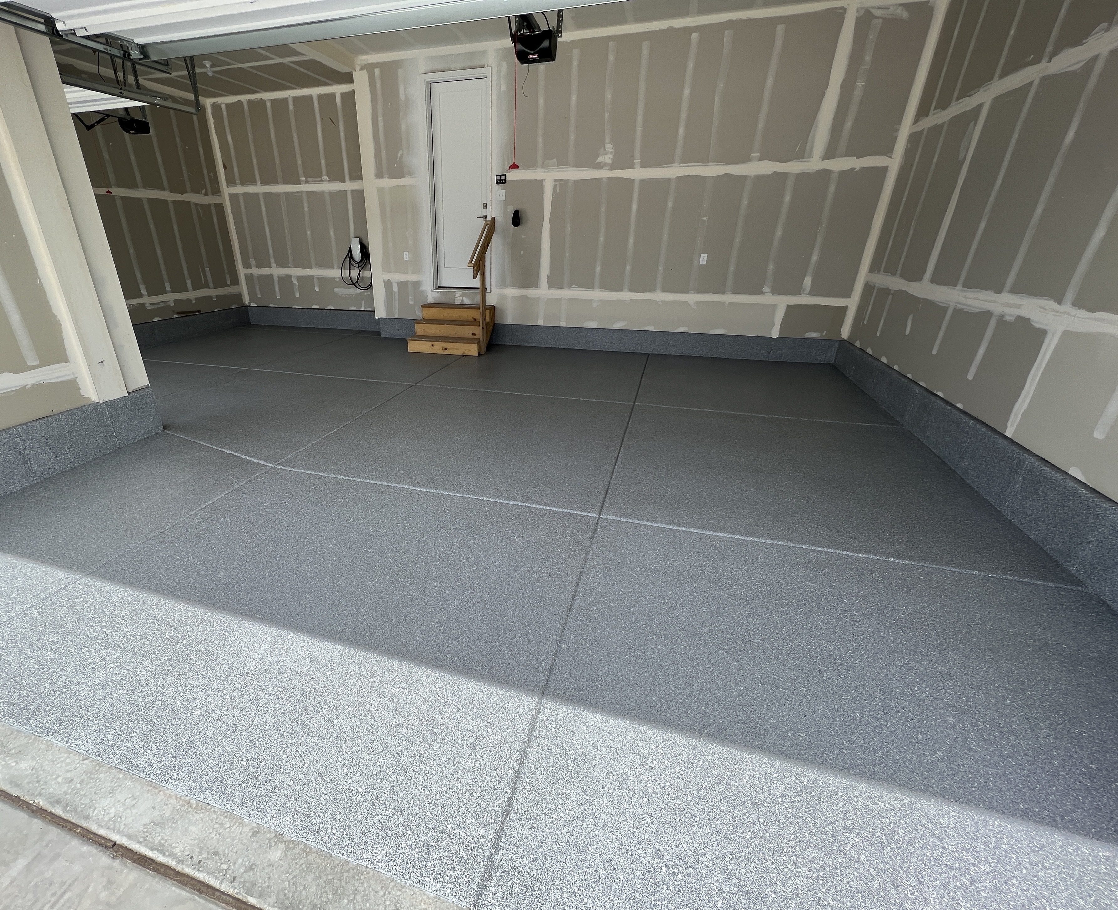 Garage with gray flake floor and integral cove base