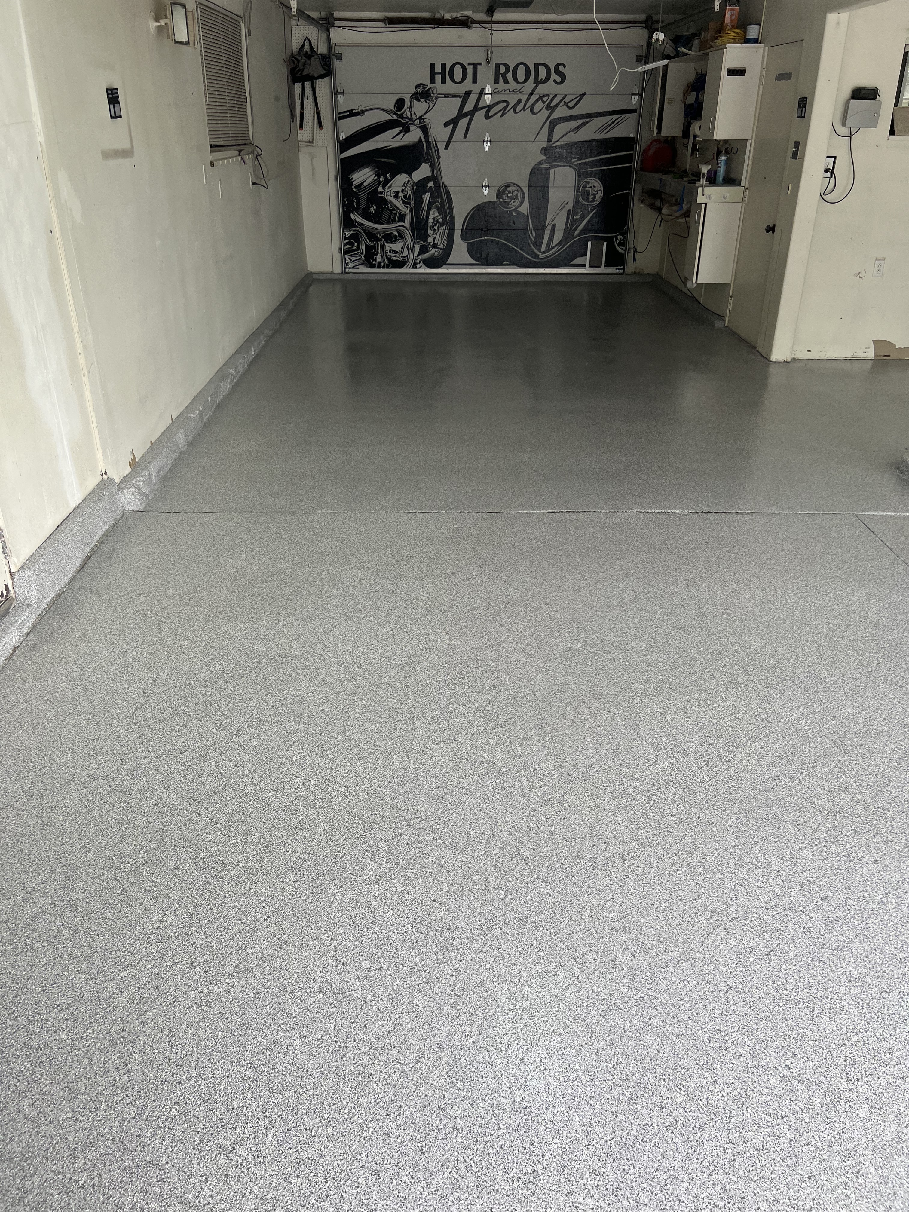 Auto shop with gray flake floor and hot rods